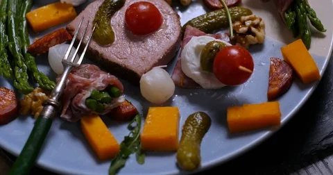 Dolly close up push in view of a platter of cured meat (charcuterie) Stock Footage 72380266