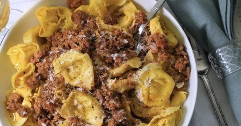 Dolly close up top down view of tortellini in bolognese sauce (pasta) Stock Footage 76181761