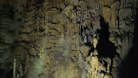 Dolly close underground cave wall crystals stalactites pattern speleology cavern Stock Footage 155038098