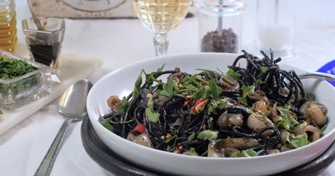 Dolly close up view of delicious black pasta with squids (cuttlefish) and ink Stock Footage 75778462