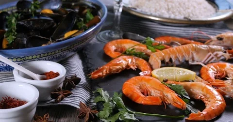 Dolly close up view of ingredient for a Spanish seafood paella Stock Footage 74067533