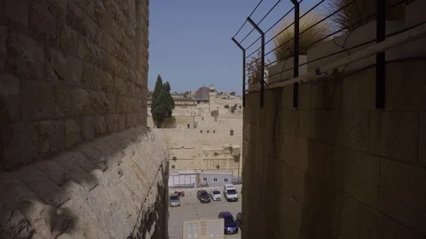 Dolly in, crane down movement from a narrow alley to the old city of jerusalem Stock Footage 93161246