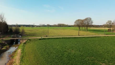 Dolly Drone Shot of Brook, Bridge, and Road in Rural Lille, Flanders Stock Footage 308938837
