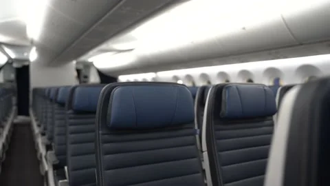 Dolly on empty blue leather seats on a commercial airplane. Stock Footage 170232170