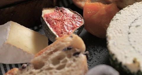 Dolly extreme close up push in view of an assortment of cheese Stock Footage 76760230