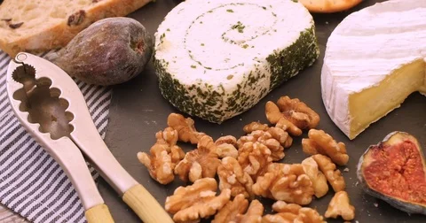 Dolly extreme close up view of an assortment of French and British cheese Stock Footage 72378746