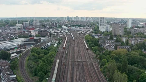 Dolly forward drone shot towards busy clapham junction train station London Video stock 155973357