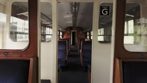 Dolly forward footage of an empty carriage with blue seats on a retro train. Stock Footage 280226989