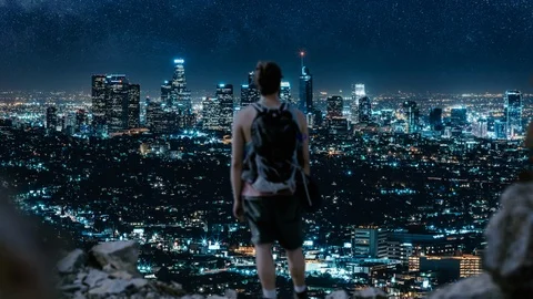 Dolly forward shot of tourist climbing contemplating a city with skyscrapers Stock Footage 125219085