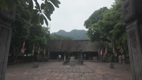 Dolly forward through a gate towards temple in Hoa Lu Stock Footage 290076614