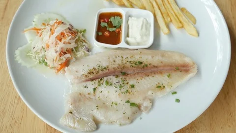Dolly grilled fish steak placed in a white dish Video stock 77263790