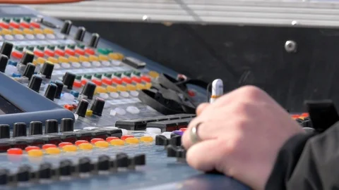 Dolly of hands controlling a sound mixing board at concert. Stock Footage 100650232