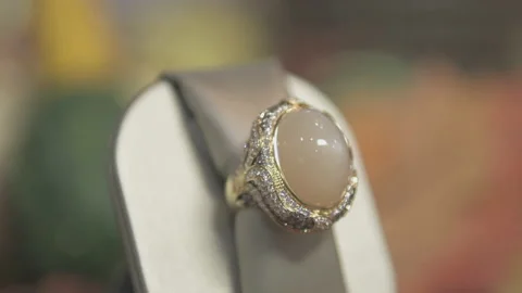 Dolly left Close up of Diamond Gold Ring with large Opal Stone in middle Stock Footage 130670549