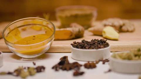 Dolly left of different spices on a table Vidéo 164629176