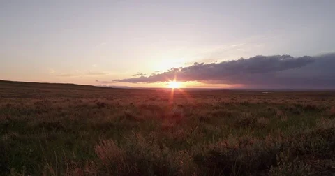 Dolly left at sunset on prairie with clouds Stock Footage 83461313