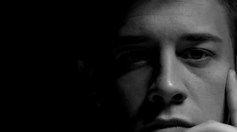 Dolly of man with hand on face in black and white Stock Footage 22956142