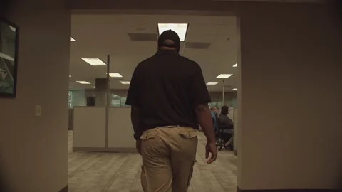 DOLLY IN-MAN WALKS THROUGH OFFICE Stock Footage 214964935