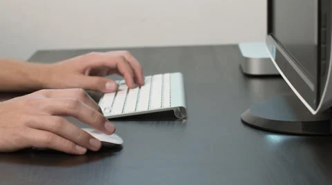Dolly In on Man Working on Desktop at Black Desk Stock Footage 50487190