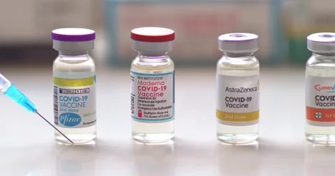 Dolly of most effective Covid-19 Vaccines vials bottles with syringes on a clear Stock Footage 147520989