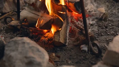 DOLLY MOTION: Cooking on fire at sunset. Cooking on fire. Travel Gear. The 스톡 동영상 76201181