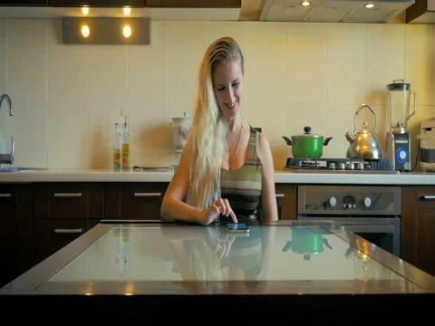 Dolly the nice girl sits at the table and writes a message on the smart-phone. Stock Footage 80602432