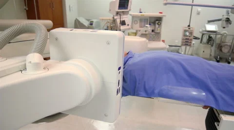 DOLLY OUT. Doctor make a scan to a patient, the image is showed in a monitor. Stock Footage 48874585