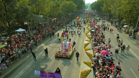 Dolly out flyover of the parade of the dead with skull statues, colorful Stock-Footage 295250935