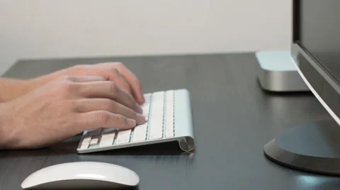 Dolly Out on Man Working on Desktop at Black Desk Stock Footage 50487412