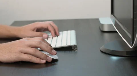 Dolly Out on Man Working on Desktop at Black Desk (4k) Stock Footage 50487964