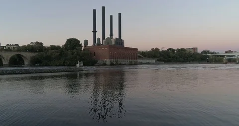 Dolly in over river of water utility building at sunset Video stock 118924821
