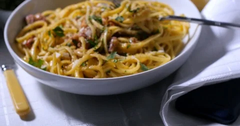 Dolly panning push out view of a delicious plate of spaghetti carbonara Stock Footage 72620588