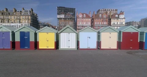 Dolly panning view of beach huts in the seafront at Brighton and Hove, England Stock Footage 80621449