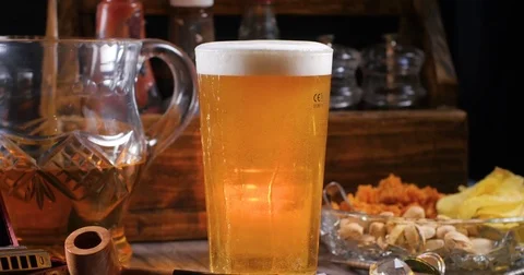 Dolly panning view of a cold refreshing pint of beer (lager) in a pub Stock Footage 77333480