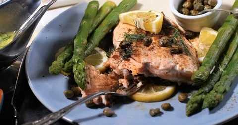 Dolly panning view of a delicious roasted organic salmon with capers and dill Stock Footage 75774701