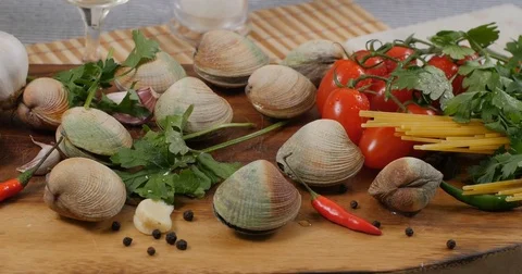 Dolly panning view of ingredients for delicious spaghetti alle vongole (clams) Stock Footage 75276590
