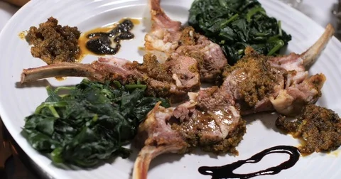Dolly panning view of ingredients for minted rack of lamb with spinach Stock Footage 73527083