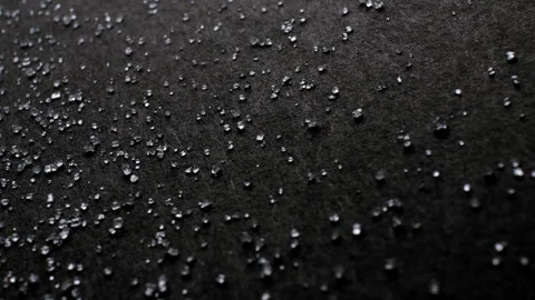 Dolly panorama of white transparent refined salt like diamond crystals on black Stock Footage 254123627