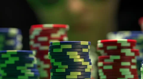 Dolly in from poker chips to player Stock Footage 22948498