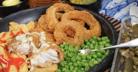 Dolly pull out view of an English fish and chips Stock Footage 78604179