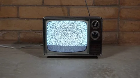 Dolly pullback of a vintage television set with static and noise Stock Footage 240951404