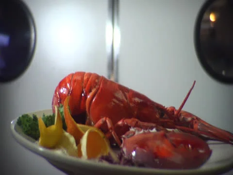 Dolly push on dinner plate out through kitchen doors Stock Footage 26189011