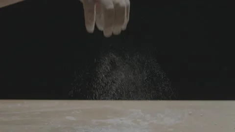 Dolly push in of hand sprinkling flour Stockbeeldmateriaal 149117494