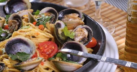 Dolly push out close up view of delicious Italian spaghetti alle vongole (clams) Stock Footage 77563611
