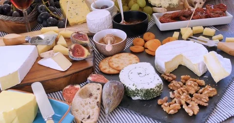 Dolly push in view of an assortment of French and British cheese Stock Footage 71845742