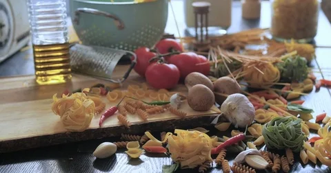 Dolly push in view of different variety of Italian pasta and ingredients Stock Footage 71580666