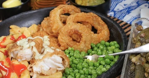 Dolly push in zoom out view of an English fish and chips Stock Footage 77147415