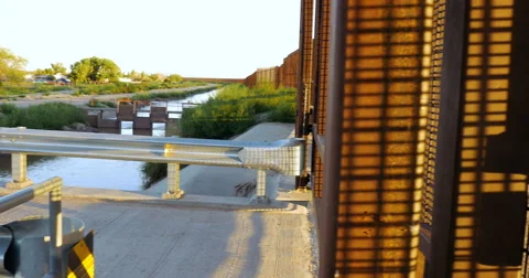 Dolly to Reveal a Large Wall Dividing the Border Between Mexico and America - 4K Stock Footage 67652424