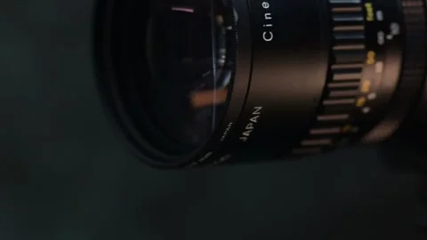 Dolly-right close-up of an old analog Super 8 camera lens on a dark Stock Footage 281098107