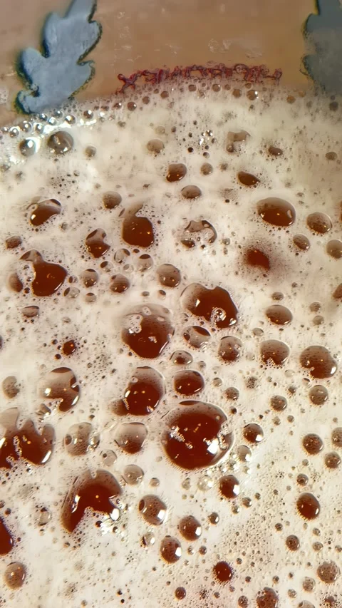 Dolly Right Over Foamy Beer and Dark Bubbles in Decorative Ceramic Vessel Stock Footage 339078440