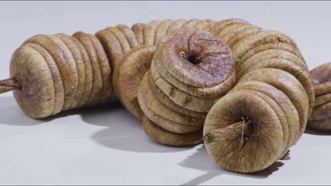 Dolly right shot of dried fig on table, white background Stock Footage 280337107